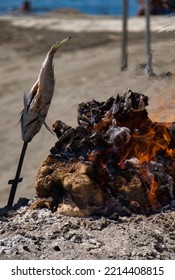 Special Andalusian Barbecue On A Sunny Day. Espeto, Grilled Fish Outdoors. Grilling Fish On The Sandy Beach. Typical Andalusian Dish. Spanish Cover.