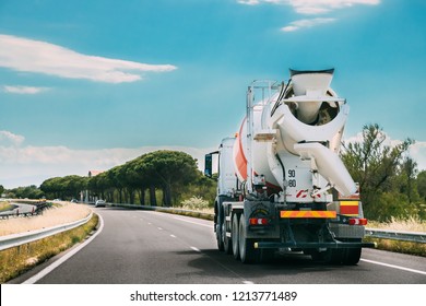 Special Concrete Transport Truck In-transit Mixer Unit In Motion On Country Road, Freeway. Freeway Motorway Highway. Business Drive Transportation And Development Concept. Concrete Truck Mixer