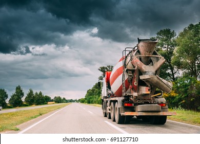 Special Concrete Transport Truck (In-transit Mixer) Unit In Motion On Country Road, Freeway In Europe. Asphalt Freeway, Motorway, Highway. Business Transportation And Development Concept