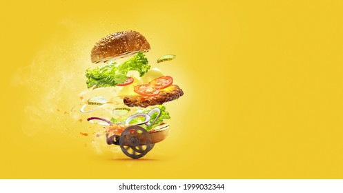 Special, Express Delivery. Hamburger With Flying Ingredients On Yellow Studio Background. Bun, Salad, Meat, Cheese And Tomatos, Onion In Flight. Fast Food, Advertising Concept. Copy Space For Ad.