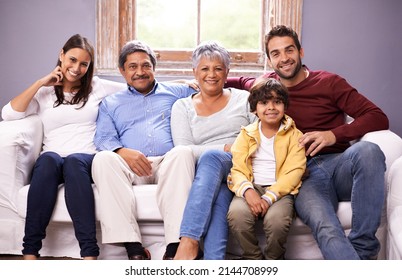 A Special Family Moment. Portrait Of A Family Bonding Together In The Living Room.