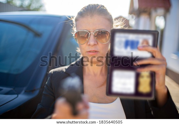 Special federal intelligence agent woman in black\
suit and big police car