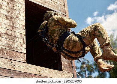 Special Forces Fighter Descends From A Skyscraper To Storm The Apartment. Police, Counter Terrorism Concept. Mixed Media