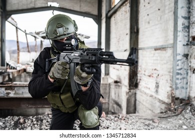 Special forces police soldier in action battle ruined building aiming riffle sniper
