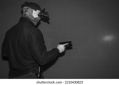 A Special Forces Soldier With A Night Vision Device And A Pistol.