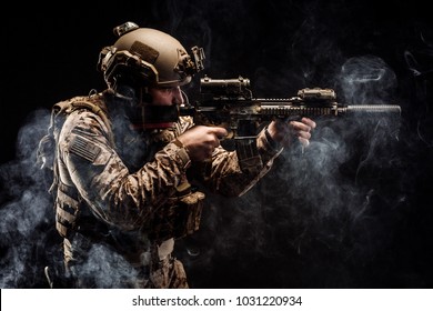 Special forces United States soldier or private military contractor holding rifle. Image on a black background. war, army, weapon, technology and people concept
