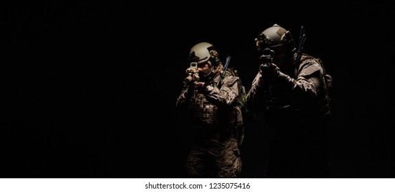 Special forces United States soldiers or private military contractors holding rifle. Image on a black background. war, army, weapon, technology and people concept