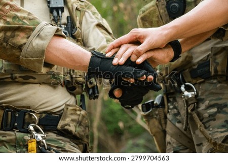 Special forces units, armed with war weapons are joining forces in unity surprise attack preparing mission to assault the enemy military.
