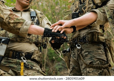 Special forces units, armed with war weapons are joining forces in unity surprise attack preparing mission to assault the enemy military.
