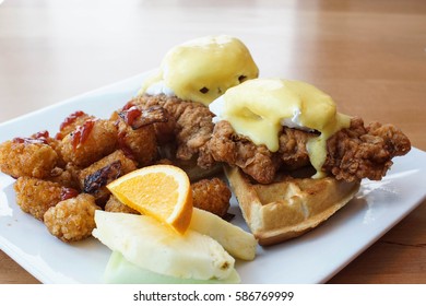 Special Fried Chicken And Waffles With Eggs Benedicts On Top With A Side Of Tater Tots