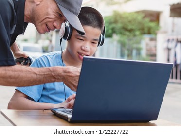 Special Need Child On Wheelchair Use Notebook In The House With His Parent, Study And Work At Home For Safety From Covid 19,Life In New Normal Education Of Special Need Kid,Happy Disabled Boy Concept.