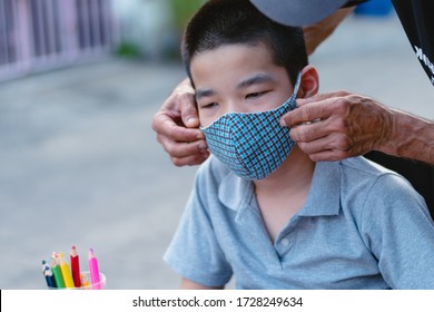 Special Need Child On Wheelchair Wearing A Cotton Mask By Parent,Boy Felt Uncomfortable And Didn't Want To Wear A Guise, Study And Working At Home For Safety From Covid 19, Education Distancing.