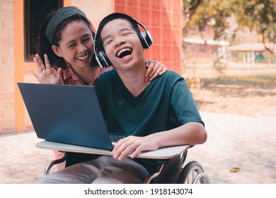 Special need child on wheelchair use a tablet in the house with his parent, Study or Work at home for safety from covid 19, Life in new normal education of special need kid,Happy disabled boy concept. - Shutterstock ID 1918143074