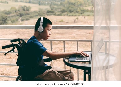 Special Need Child On Wheelchair Happy Time To Use A Notebook In The House, Study And Work At Home For Safety From Covid 19, Life In The Education Age Of Special Need Kid, Happy Disabled Boy Concept.