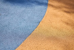 Special Rubber Coating For The Playground Or Sports Activity. Junction Of Multicolored Pieces Of Floor Covering Made Of Recycled Materials. Padded Floor Covering With Rubber Granules.