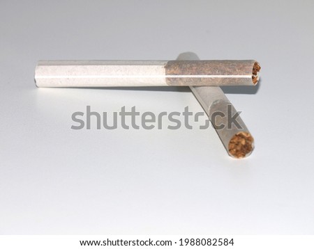 
Special Russian cigarette without a filter with cardboard mouthpiece  (papirosa)  on a white background. Spot selective focus with Shallow DOF.