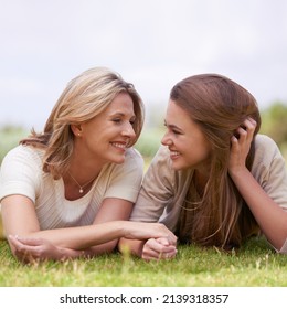 Special Time With Her Daughter. A Loving Mother And Daughter Lying Side By Side On The Grass.