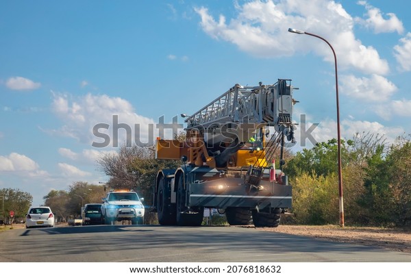 special transport heavy duty crane 55 tons on the\
highway with an escort\
car