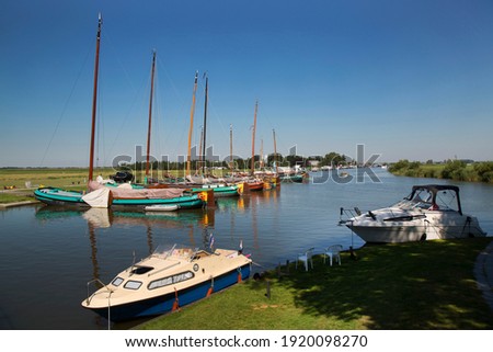 Image, Stock Photo A flat bottom ship sails by with full sails, clouds are in the sky over the sea