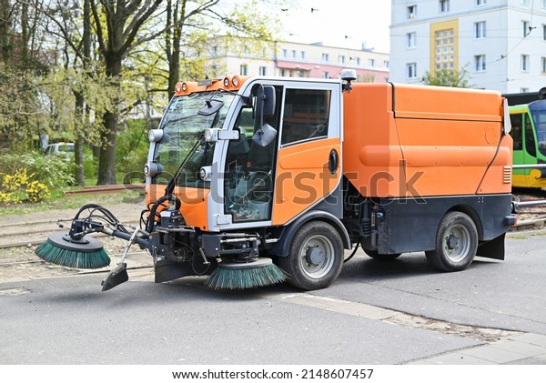 special vehicle for cleaning the\
road from dirt brushes the city street. road industry\
service