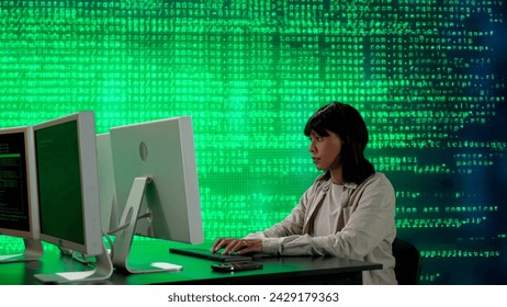 IT specialist against big digital screen. African american woman programmer works on computer in front of screen digital code data process.