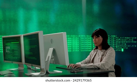 IT specialist against big digital screen. African american woman programmer works on computer in front of screen digital code data process.