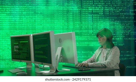 IT specialist against big digital screen. African american woman programmer works on computer in front of screen digital code data process.