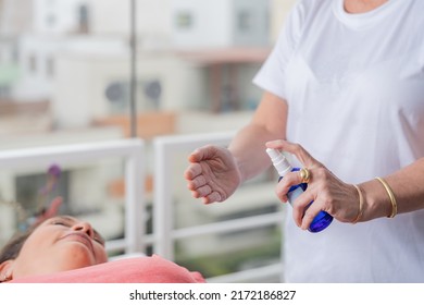 Specialist Applying An Aromatherapy Spray To A Relaxed Patient On A Stretcher