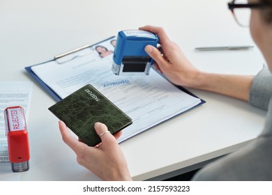 Specialist Approving Visa Application At Table - Shutterstock ID 2157593223