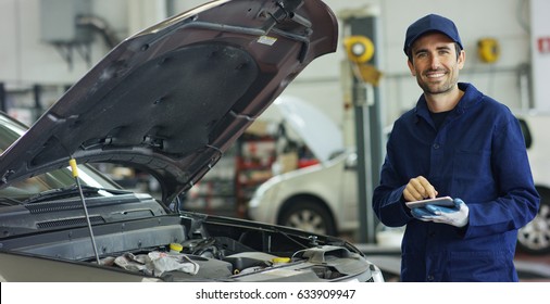 Specialist Auto Mechanic In The Car Service, Checks The Car, Engine, Engine, Carburetor. Concept: Repair Of Machines, Fault Diagnosis, Repair Specialist, Technical Maintenance And On-board Computer.