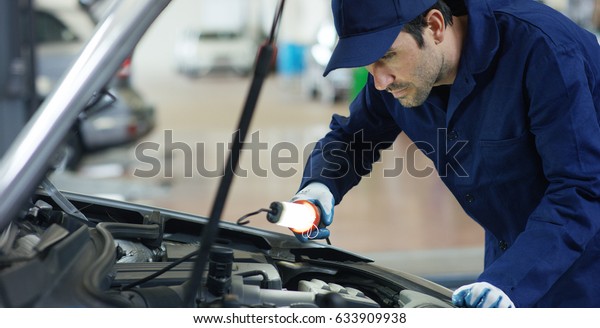 Specialist auto mechanic in the car service,\
checks the car, engine, engine, carburetor. Concept: repair of\
machines, fault diagnosis, repair specialist, technical maintenance\
and on-board\
computer.