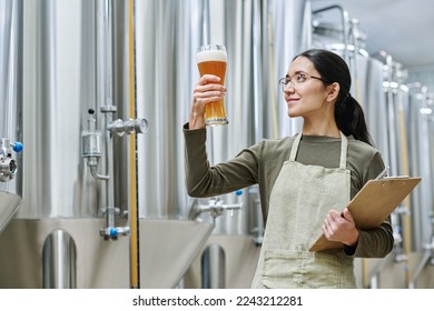 Specialist checking the beer in brewing plant - Powered by Shutterstock