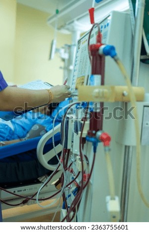 The specialist are checking continuous renal replacement therapy equipment and injection pump and hemodialysis machine.