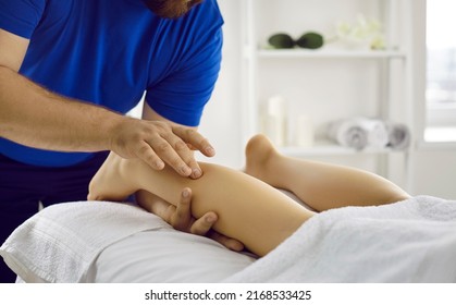 Specialist Doing Leg Massage For Female Patient. Qualified Physiotherapist, Osteopath, Manual Therapist Or Chiropractor Massaging Calf Muscles Of Young Woman. Therapy, Treatment, Physiotherapy Concept