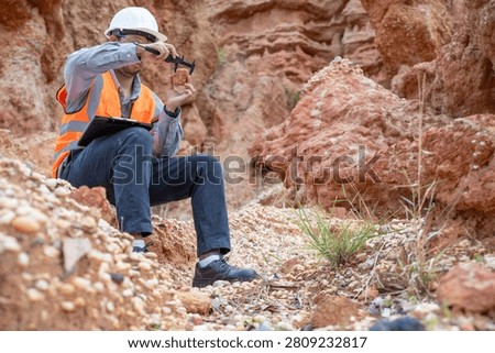A specialist geologist is analyzing soil samples from inside a natural sinkhole for further study.