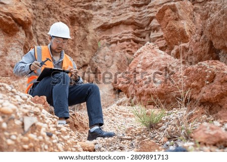 A specialist geologist is analyzing soil samples from inside a natural sinkhole for further study.