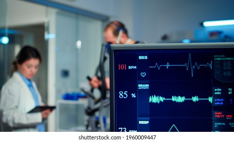 Specialist Health Supervisor Increasing Level Of Exercises Measuring Muscle Endurance Of Athlete. Medical Researcher Measuring Vo2 Of Performance Sports Running With Mask On Cross Trainer In Sport Lab