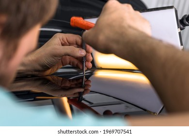 A Specialist Repairs A Dent On A Car Body. PDR