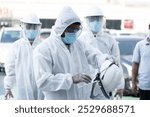 Specialist team using hazmat suits cleaning disinfecting Spraying