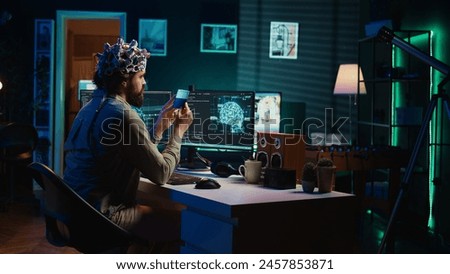IT specialist using EEG headset and deep learning technology to upload brain into computer. Close up of neuroscientific equipment used by man transferring consciousness into cyberspace, camera B