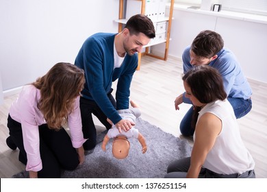 Specialist Using Infant Dummy For Giving Training To Colleagues - Powered by Shutterstock