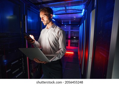 IT specialist using security appliance and laptop for server administration