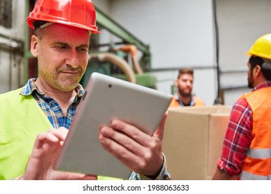 Specialist Warehouse Clerk Checks A Delivery On The Tablet PC In The Shipping Company Or In The Metal Factory