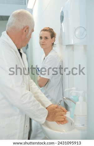 Similar – Female doctor filling out questionnaire to a senior patient