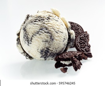 Speciality American oreo ice cream with crushed cookies alongside as ingredients isolated on white showing the texture of the scoop