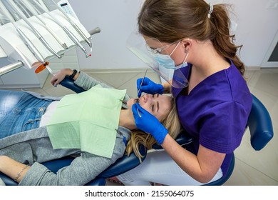 in a specialized dental clinic, a female dentist receives clients with problem teeth. Dental treatment concept