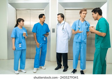 Specialized doctor medical center and hospital health care services. Group of doctor and nurse talking discussion about surgical and patient care during waiting for elevator in hospital corridor. - Powered by Shutterstock