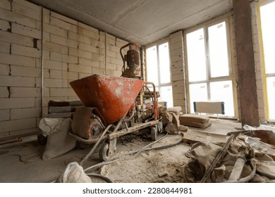 A specialized mixer for mixing dry plaster with water and automatically feeding the finished plaster. - Powered by Shutterstock