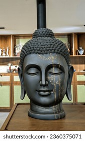 Specifically a Buddha head is carved to represent the Buddha's wisdom along with the serene smile of the face symbolizing the Buddha's peaceful and calm nature.