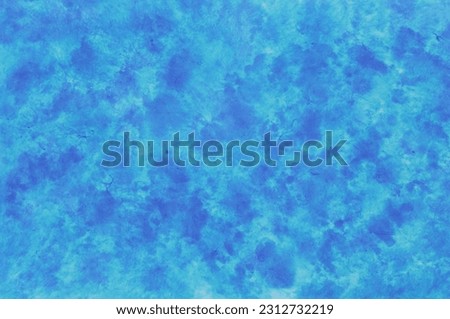Speckled background of paper colored in shades of blue